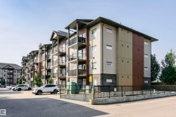 Multi-story residential building featuring a modern facade with mixed siding materials and stone accents - 