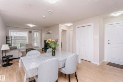 Open-concept living and dining area with wood-finish flooring - 
