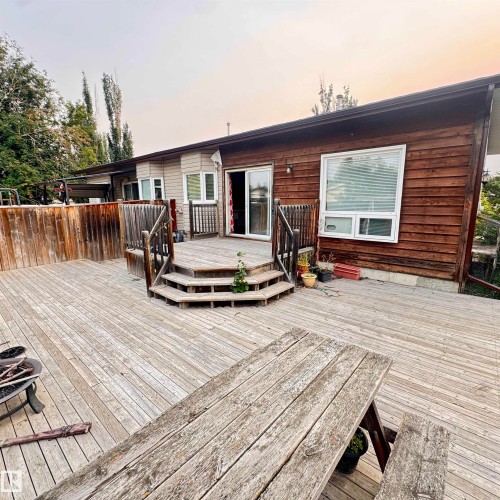 Expansive composite deck featuring multiple levels with wood-finish decking, integrated seating areas, and substantial square footage for entertaining - 4821 11A Avenue Nw, Edmonton, AB - Outdoor With Deck Patio Veranda With Exterior