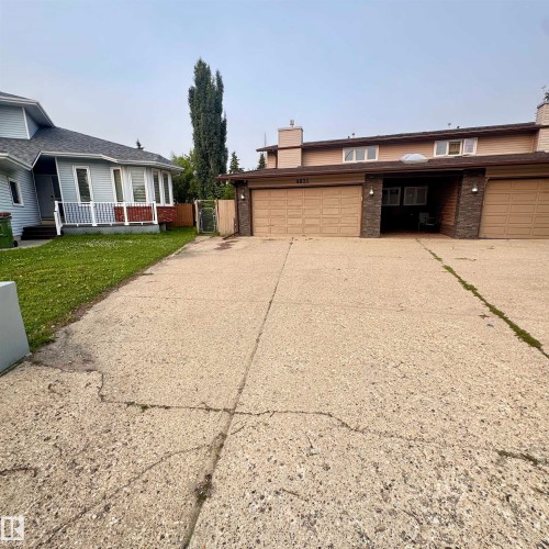 Expansive driveway featuring concrete construction with defined sections, providing ample parking and vehicle access - 4821 11A Avenue Nw, Edmonton, AB - Outdoor