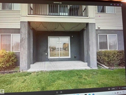 Ground-level patio with sliding glass door access - #106 592 Hooke Rd Nw, Edmonton, AB 