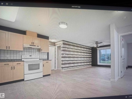 Open-concept living space featuring wood-finish flooring throughout, a kitchen with light-toned cabinetry and white tile backsplash, a white electric range, and a ceiling fan with integrated lighting - #106 592 Hooke Rd Nw, Edmonton, AB 