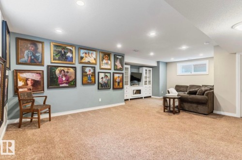 Spacious finished lower level featuring recessed lighting, a built-in media center, and light-tone carpeting - 22 Voleta Crest, Spruce Grove, AB - Indoor