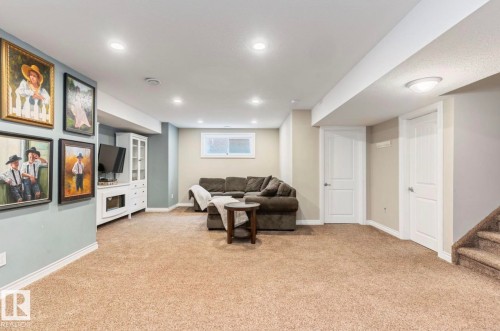 Spacious finished basement featuring neutral carpet flooring, recessed ceiling lighting, and multiple white interior doors - 22 Voleta Crest, Spruce Grove, AB - Indoor Photo Showing Basement