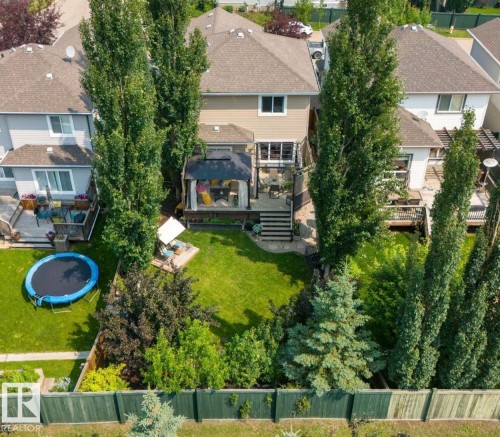 Expansive backyard featuring a multi-tiered deck, built-in gazebo, and mature trees providing natural privacy - 22 Voleta Crest, Spruce Grove, AB - Outdoor With Deck Patio Veranda