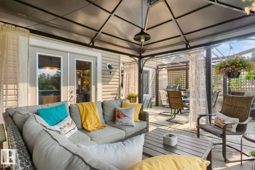 Expansive outdoor living area featuring a covered patio with a metal frame gazebo and integrated lighting - 22 Voleta Crest, Spruce Grove, AB - Outdoor With Deck Patio Veranda With Exterior