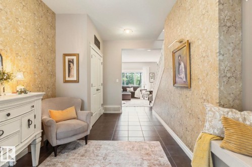 Elegant hallway showcasing neutral wallcovering with subtle pattern detail, dark wood-finish flooring, and recessed ceiling lighting - 22 Voleta Crest, Spruce Grove, AB - Indoor Photo Showing Other Room