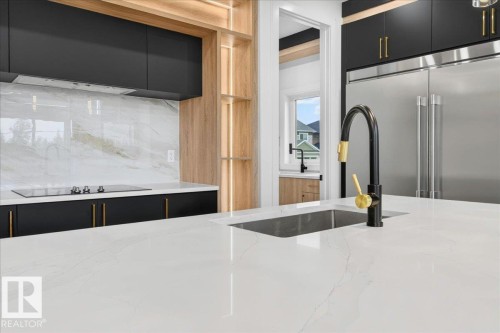 Kitchen island featuring a white countertop with subtle veining - 403 172 Avenue Nw, Edmonton, AB - Indoor Photo Showing Kitchen With Upgraded Kitchen