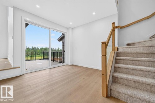 Spacious room featuring light wood-finish flooring and recessed lighting - 403 172 Avenue Nw, Edmonton, AB - Indoor Photo Showing Other Room