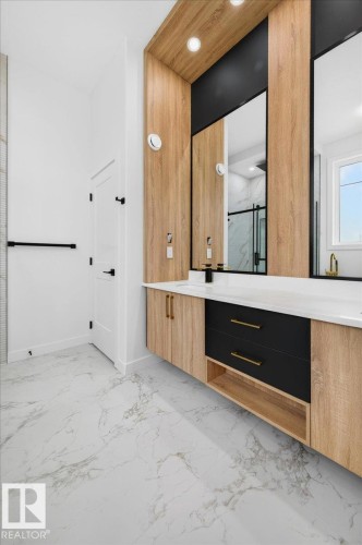 Bathroom featuring a floating wood-finish double vanity with black drawers and gold hardware - 403 172 Avenue Nw, Edmonton, AB - Indoor Photo Showing Other Room