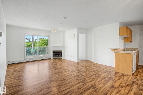 #203 8119 112 Av Nw, Edmonton, AB - Indoor With Fireplace