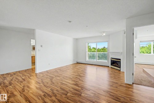 #203 8119 112 Av Nw, Edmonton, AB - Indoor Photo Showing Living Room With Fireplace