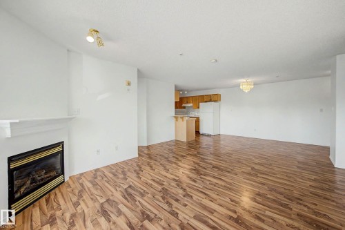 #203 8119 112 Av Nw, Edmonton, AB - Indoor Photo Showing Living Room With Fireplace