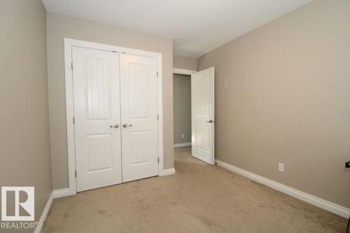 Neutral painted walls complement the textured beige carpeting - 3048 Harvey Crescent Nw, Edmonton, AB - Indoor