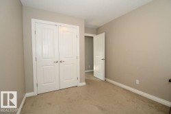 Neutral painted walls complement the textured beige carpeting - 