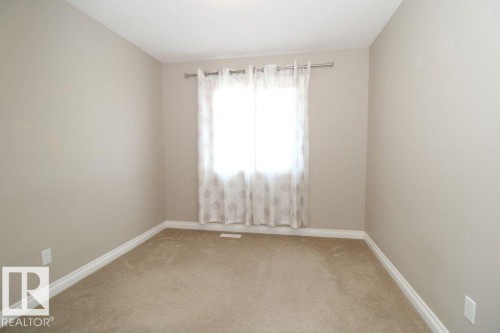 Neutral-toned room with light beige wall paint, white baseboards, and a beige carpeted floor - 3048 Harvey Crescent Nw, Edmonton, AB - Indoor Photo Showing Other Room
