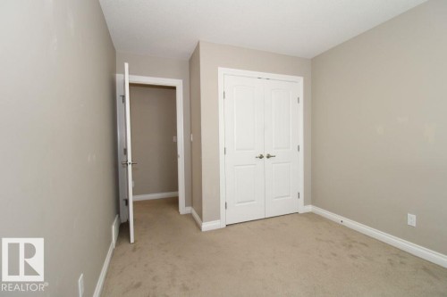Neutral-toned room featuring a soft beige carpet, painted walls, and white baseboards - 3048 Harvey Crescent Nw, Edmonton, AB - Indoor Photo Showing Other Room