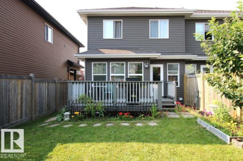 Rear exterior featuring a spacious deck with perimeter railing and steps to the lawn - 3048 Harvey Crescent Nw, Edmonton, AB - Outdoor With Deck Patio Veranda