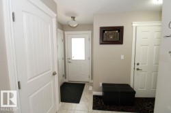 Entryway featuring light neutral wall paint and a semi-flush mount ceiling light - 