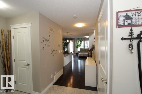 Entryway featuring light-toned walls, contrasting dark wood-finish flooring, and white trim - 3048 Harvey Crescent Nw, Edmonton, AB - Indoor Photo Showing Other Room