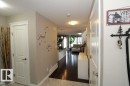 Entryway featuring light-toned walls, contrasting dark wood-finish flooring, and white trim - 3048 Harvey Crescent Nw, Edmonton, AB  - Indoor Photo Showing Other Room 
