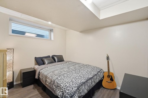 Recessed window with white trim, crown molding, and wood-finish flooring - 215 85 Street Sw, Edmonton, AB 