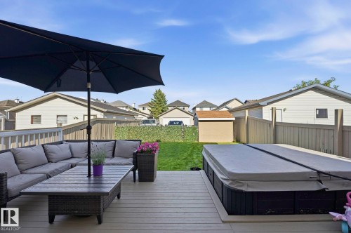 Expansive backyard deck featuring a built-in hot tub - 215 85 Street Sw, Edmonton, AB 