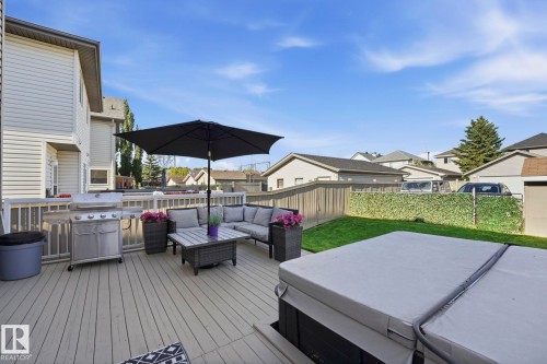 Spacious deck with a multi-level design, composite decking, and white railing - 215 85 Street Sw, Edmonton, AB 