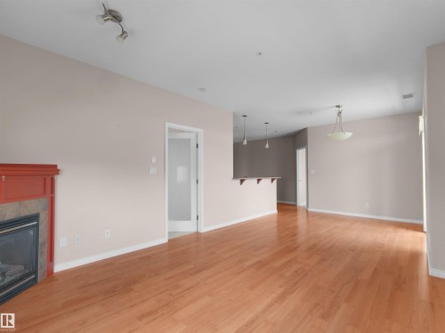 #241 2503 Hanna Cres Nw, Edmonton, AB - Indoor Photo Showing Other Room With Fireplace