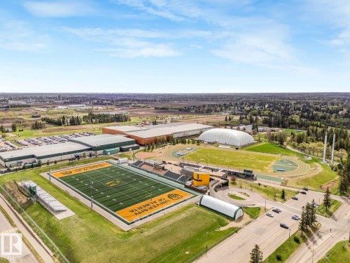 Aerial perspective showcasing a large sports complex featuring a prominent football field with stadium seating, multiple athletic tracks, a baseball diamond, and an inflatable dome structure - 11613 72 Avenue Nw, Edmonton, AB - Outdoor With View