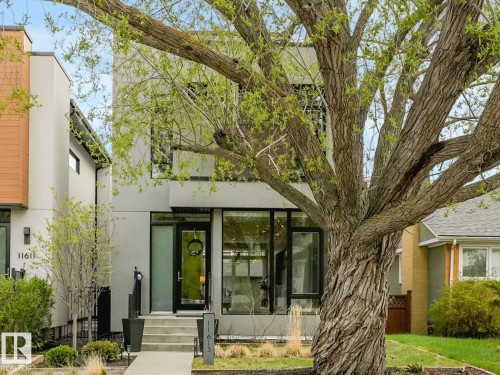 Contemporary architectural design featuring a multi-story facade, prominent large windows, and a modern entrance - 11613 72 Avenue Nw, Edmonton, AB - Outdoor