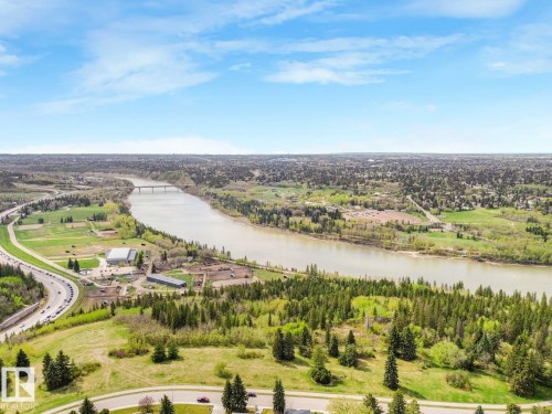 Riverfront setting featuring extensive green spaces, a bridge crossing the river, and scattered urban infrastructure - 11613 72 Avenue Nw, Edmonton, AB - Outdoor With View