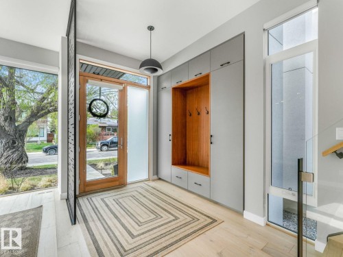 Foyer featuring light wood-finish flooring and an integrated entryway storage system - 11613 72 Avenue Nw, Edmonton, AB - Indoor Photo Showing Other Room