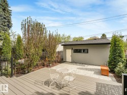 Spacious outdoor deck with composite decking and black metal railings - 