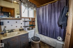 Bathroom featuring a shower-tub combination, a vanity with integrated sink, and a framed medicine cabinet - 