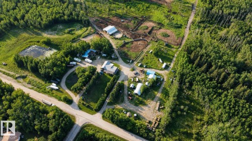 Expansive property featuring wooded areas, open fields, multiple outbuildings, and a pond - 11218 Twp Rd 590, Rural St. Paul County, AB - Outdoor With View