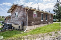 Log-style siding exterior with a white gutter system - 