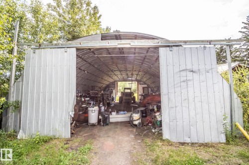 Quonset hut-style metal structure featuring a corrugated metal exterior and a curved roof - 11218 Twp Rd 590, Rural St. Paul County, AB - Outdoor