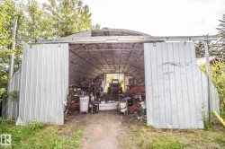 Quonset hut-style metal structure featuring a corrugated metal exterior and a curved roof - 