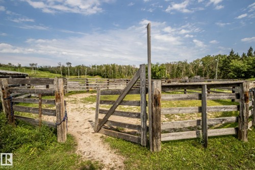 Expansive outdoor pen system featuring wood fencing and an open gate - 11218 Twp Rd 590, Rural St. Paul County, AB - Outdoor With View