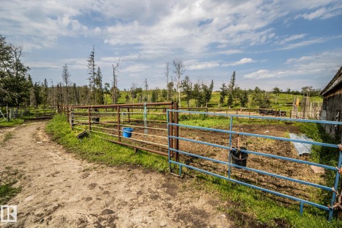 Expansive rural property featuring metal pipe fencing, a dirt path, and open pastureland - 11218 Twp Rd 590, Rural St. Paul County, AB - Outdoor With View