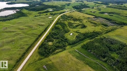 Expansive green fields, natural water features, and significant tree coverage - 11218 Twp Rd 590, Rural St. Paul County, AB - Outdoor With View