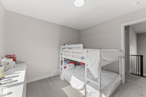Carpeted bedroom featuring neutral wall tones and a ceiling-mounted light fixture - 12383 176 Avenue Nw, Edmonton, AB - Indoor Photo Showing Bedroom