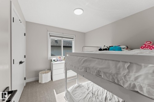 Bedroom featuring a window with blinds, light gray wall paint, and gray carpet flooring - 12383 176 Avenue Nw, Edmonton, AB - Indoor Photo Showing Bedroom