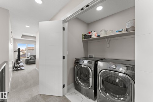 Dedicated laundry closet with shelving - 12383 176 Avenue Nw, Edmonton, AB - Indoor Photo Showing Laundry Room