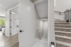 Carpeted staircase with integrated step lighting and black metal spindles - 
