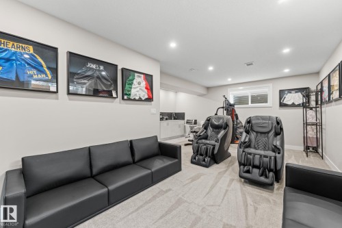 Spacious interior room featuring light gray walls and a light-colored patterned carpet - 12383 176 Avenue Nw, Edmonton, AB - Indoor
