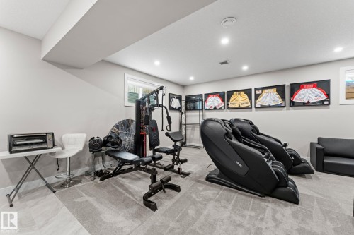 Finished basement space featuring recessed lighting, light gray walls, and carpeted flooring - 12383 176 Avenue Nw, Edmonton, AB - Indoor Photo Showing Gym Room