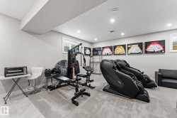 Finished basement space featuring recessed lighting, light gray walls, and carpeted flooring - 
