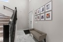 Welcoming entryway featuring marble-pattern tile flooring, neutral wall finishes, and a custom framed gallery wall displaying six coordinating art pieces - 12383 176 Avenue Nw, Edmonton, AB  - Indoor Photo Showing Other Room 